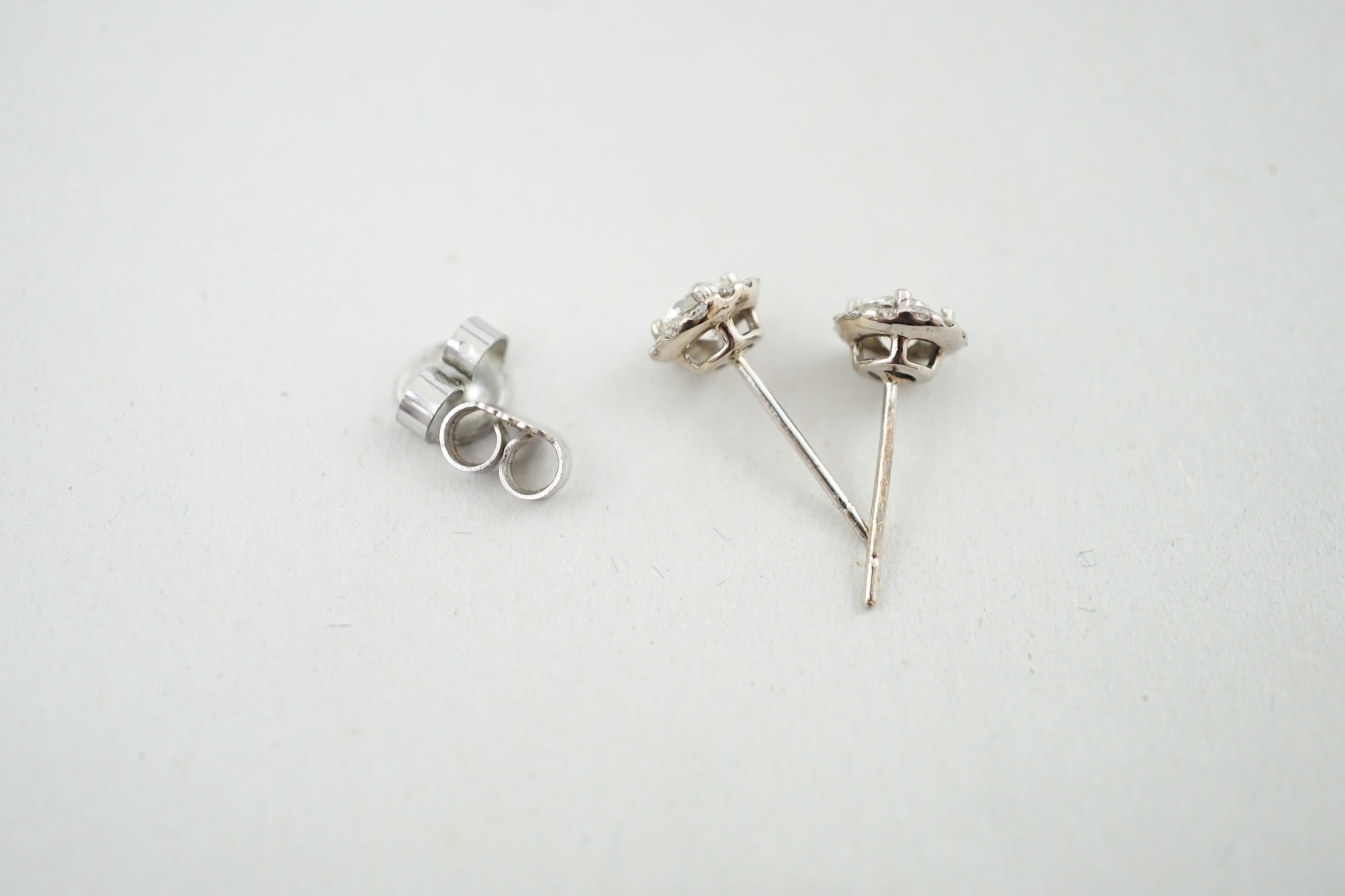 A modern pair of 18ct white gold and diamond cluster set ear studs